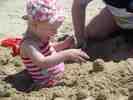 Burying her feet in the sand